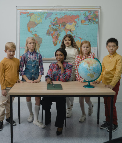 Teacher and students stand at a table